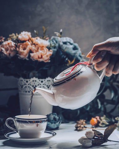 Hand Holding A Cup With Herbal Tea